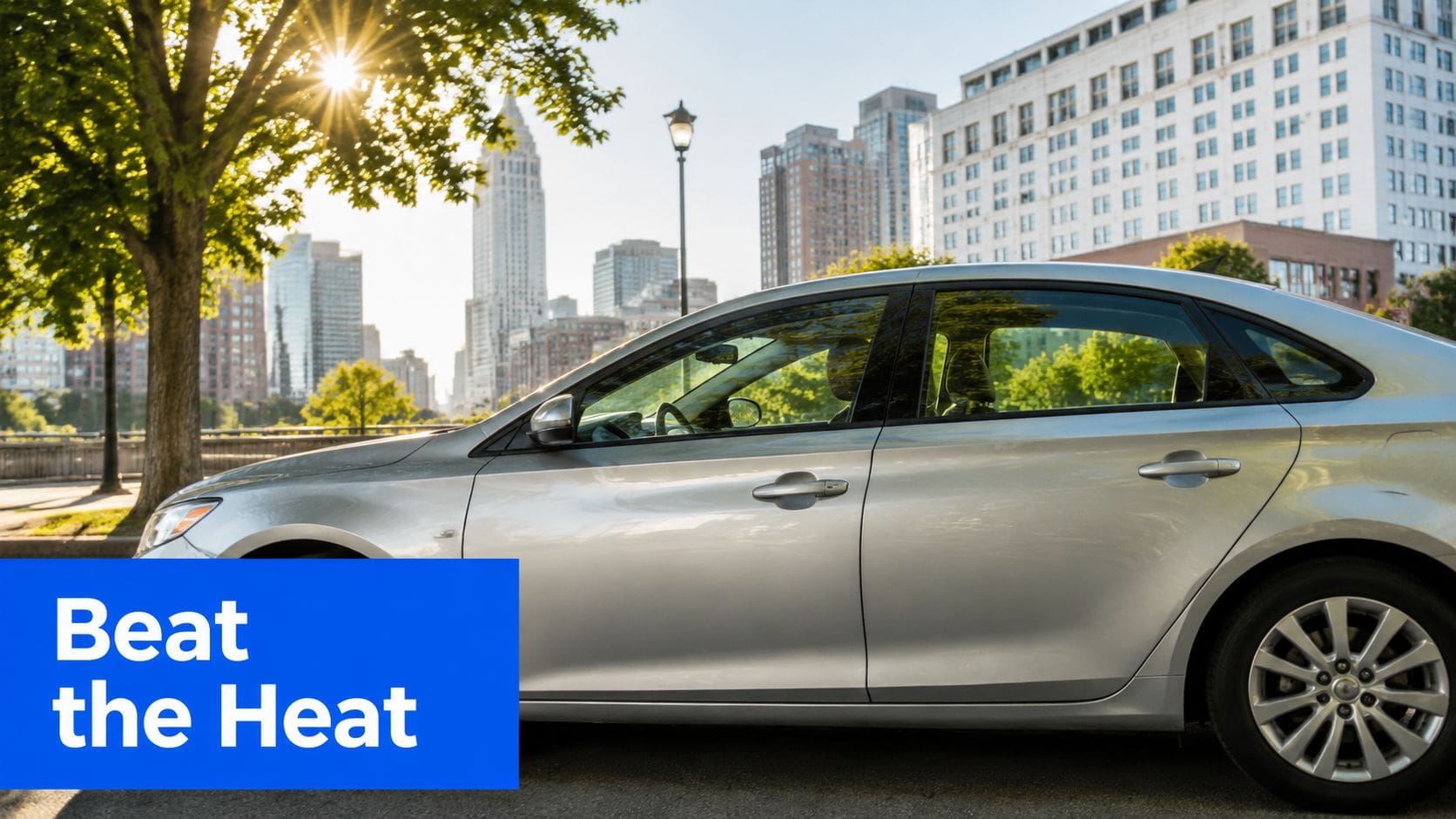 A silver sedan parked in a sunny city setting, perfect for discussing professional window tinting services.